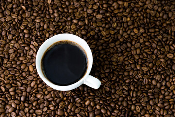 Cup of coffee on beans