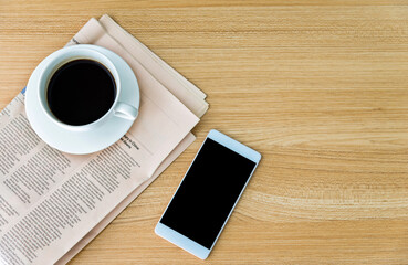 Fototapeta na wymiar Newspapers, coffee and smartphone on wooden table with top view