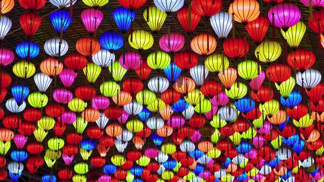 Low angle shot of colorful lantern lit up in the ceiling along the streets of Lang Son City, Vietnam at night time.