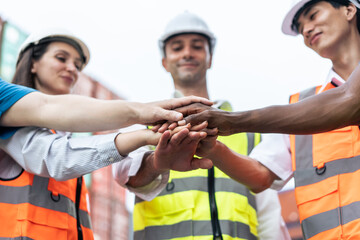 Group of young male and female worker working in container terminal.
