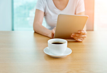 Woman using her tablet pc in cafe