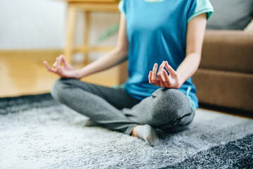 stress relief, muscle relaxation, breathing exercises, exercise, meditation, portrait of Young Asian woman relaxing her body from office work by practicing yoga by watching online tutorials