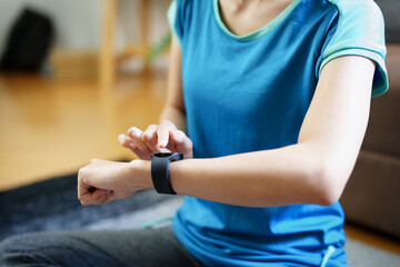 Health care, heart rate monitor, portrait of Asian beautiful woman using smart watch to select health programs such as yoga, cardio exercises, breathing meditation. to prepare before the activity