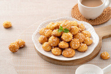 Delicious French Chouquette Choux Pastry dessert Pearl Sugar Puff on wooden table background.