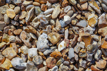pebble stone background. various shape and color stones on shingle beach. 