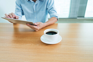 Man using digital tablet in coffee shop