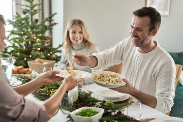 Caucasian man sharing ravioli at the Christmas Eve     