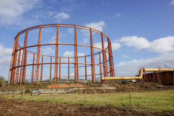 empty gas works storage cylinder and pipeline. Industrial structure in city 