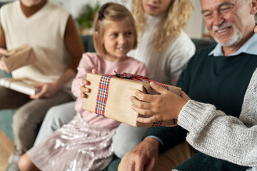 Multi generation caucasian family opening Christmas presents at home