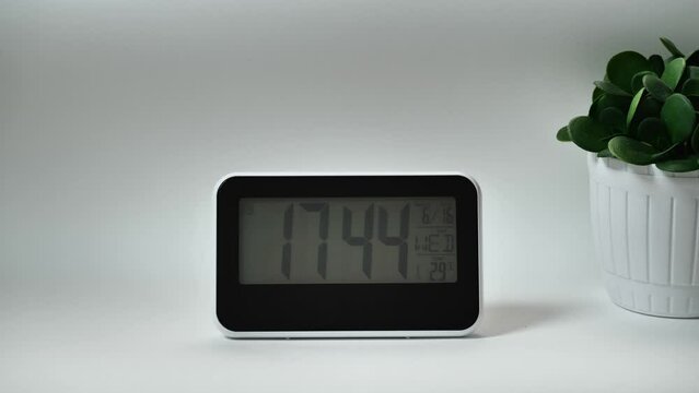 Digital clock with 17: 44hours, you can choose any hour or minute. Grey background. 1 frame per minute. Loopable.