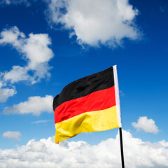 German flag waving against blue sky