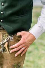 Vertical shot of mans hand in pocket in traditional bavarian outfit Oktoberfest in Munich Germany