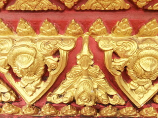 Fototapeta na wymiar Traditional Thai style stucco on the wall of church in temple, Thailand.