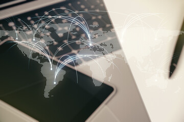Double exposure of abstract digital world map with connections on laptop background, research and strategy concept