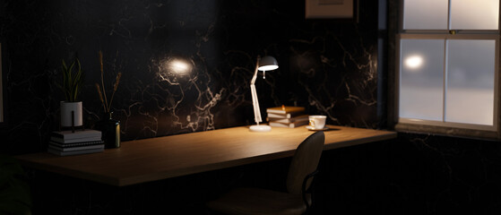 Home working space at night with space on wooden tabletop, and black marble wallpaper