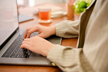 close-up image, A female worker or businesswoman using laptop computer