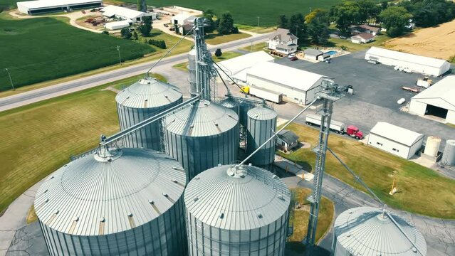 Aerial view of metal silos for grain storage. Modern grain storage plant, grain storage tanks - a flight around Metal silos