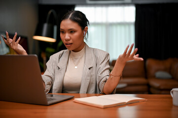 Asian female boss feels dissatisfied, disappointed, and angry with her employee's work.