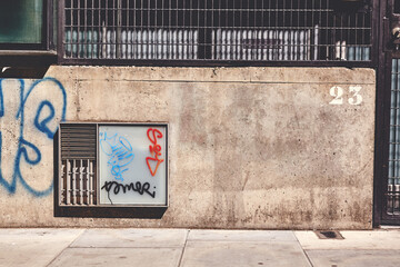 An cement wall with graffiti