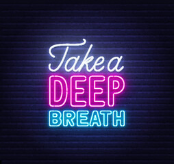 Take a Deep Breath neon quote on brick wall background.