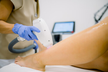 Crop specialist removing leg hair with laser
