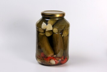 Glass jar with pickles on a white background