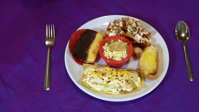 horizontal panning view of a plate with mexican food on a colorful purple background