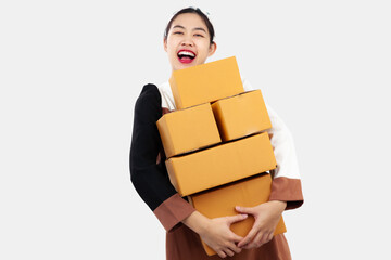 Young asian girl holding and carrying brown boxes for shipping to the client online selling business at home.