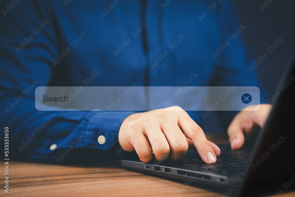 Poster Businessman's hand working with computer laptop on desk in home. Searching Browsing Internet Data Information with blank search bar. Search Engine Optimization SEO Networking Concept.