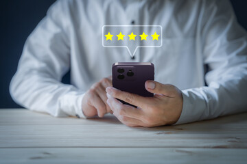 Man using a smartphone in give rating to service experience on application. Online customer review satisfaction feedback survey. - obrazy, fototapety, plakaty