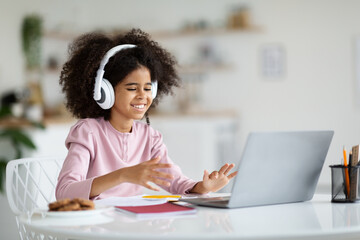 African american girl schooler having video call with tutor