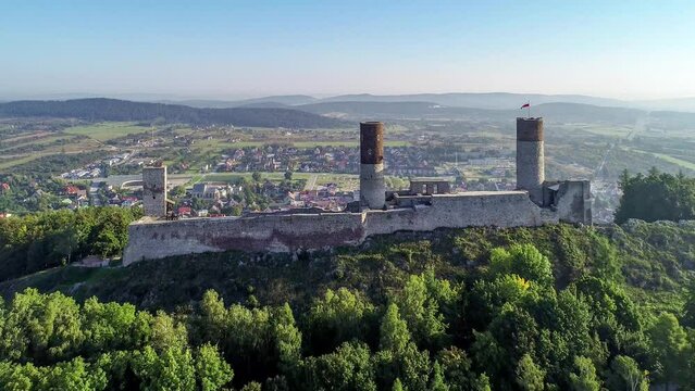 Ruin of medieval royal castle in Checiny near Kielce in Poland. Built in late 13th century. Partly renovated. Aerial 4K revealing clip in sunrise light