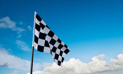 Checkered flag on blue sky