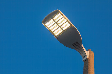parking lot LED light on a post at sunset © Mark