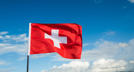 Swiss flag waving against sky
