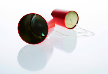 Red tin cans telephone isolated on white background