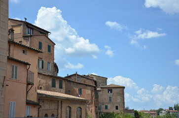 Fototapeta na wymiar The beautiful countryside and town of Siena in Tuscany on a bright summer day with its typical Tuscan medieval style