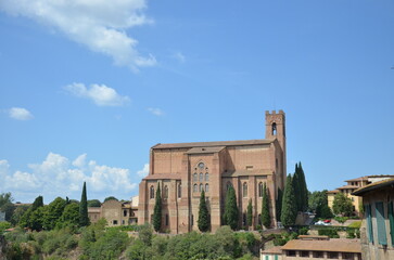 The beautiful countryside and town of Siena in Tuscany on a bright summer day with its typical Tuscan medieval style