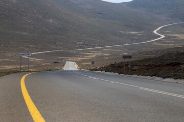 Sani mountain pass tar road with sky and clouds out of focus with grain