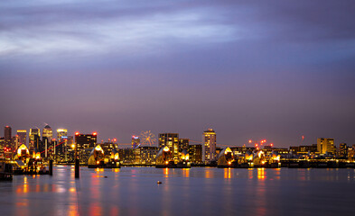 Fototapeta na wymiar Long exposure view of Canary Wharf and Thames barrier in London