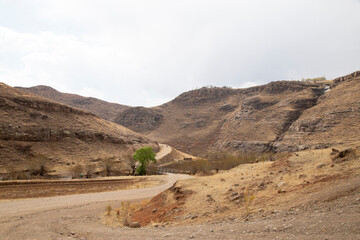 Fototapeta na wymiar mountain gravel road pass in Lesotho winter dry season out of focus with grain