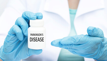 Parkinson's Disease inscription on the label of the jar in the doctor's hand. Medical concept