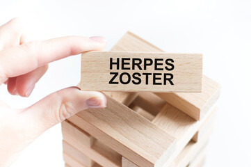 the word HERPES ZOSTER is written on a wooden cubes structure .