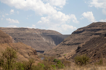 Katse Lesotho dam with dam wall and mountains clouds and blue skies