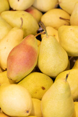 Pear on the market counter. Pile of ripe pears