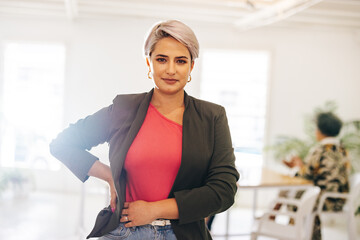 Businesswoman looking at the camera in a creative office