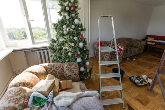 High Angle View Of Christmas Tree With Messy Boxes On Floor Of New Apartments.