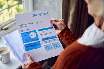 Close Up Of Senior Woman Opening UK Energy Bill Concerned About Cost Of Living Energy Crisis - obrazy, fototapety, plakaty