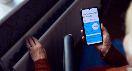 Senior Woman In Wheelchair With Mobile Phone Reviews Online USA Energy Bill In Cost Of Living Crisis