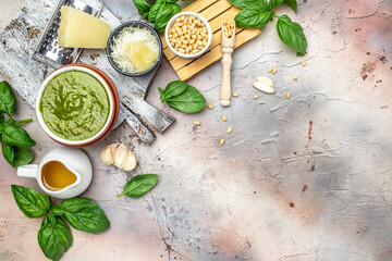 Italian basil pesto sauce bowl with green pesto pine nuts, parmesan and garlic. Long banner format. top view